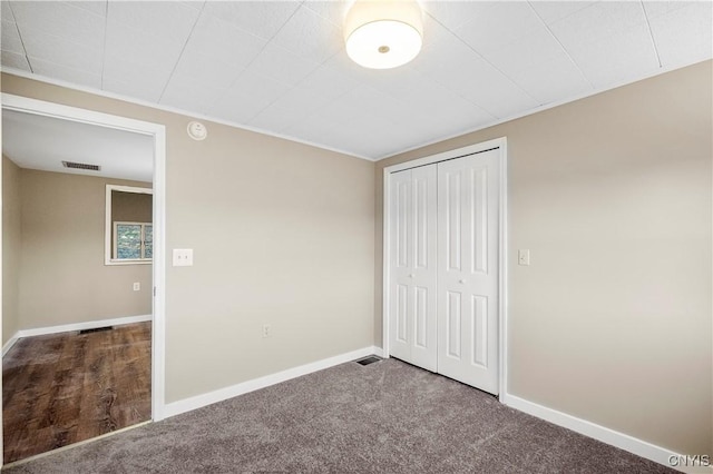 unfurnished bedroom with carpet floors and a closet