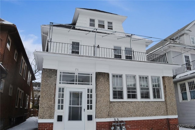 view of front of house featuring a balcony