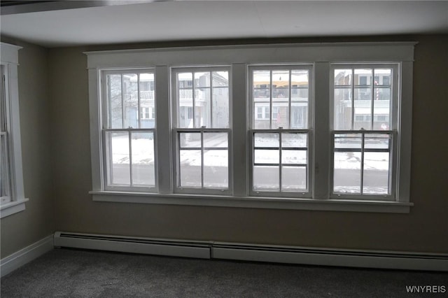 entryway with carpet, a wealth of natural light, and a baseboard heating unit