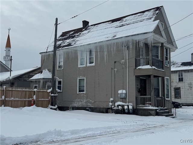 view of snow covered exterior featuring a balcony