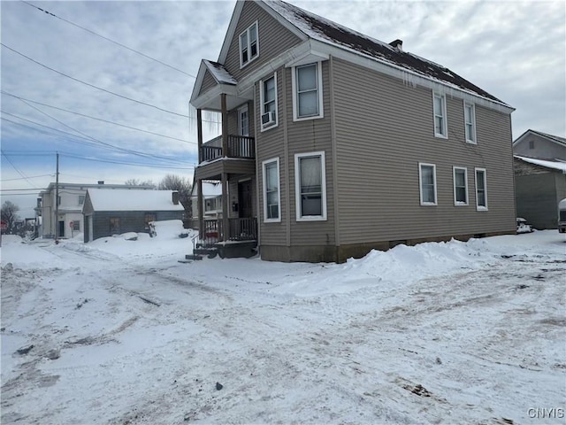 view of snow covered exterior with a balcony