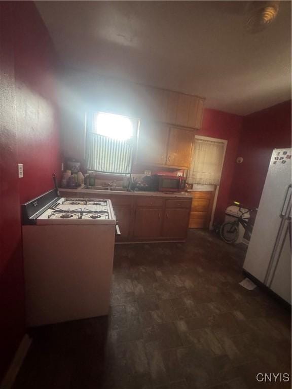 kitchen with stainless steel microwave and white range with gas stovetop