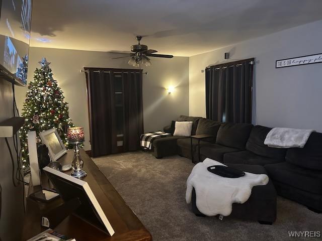 living room featuring carpet and ceiling fan