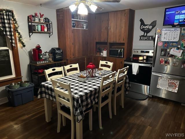 dining space featuring dark hardwood / wood-style floors and ceiling fan