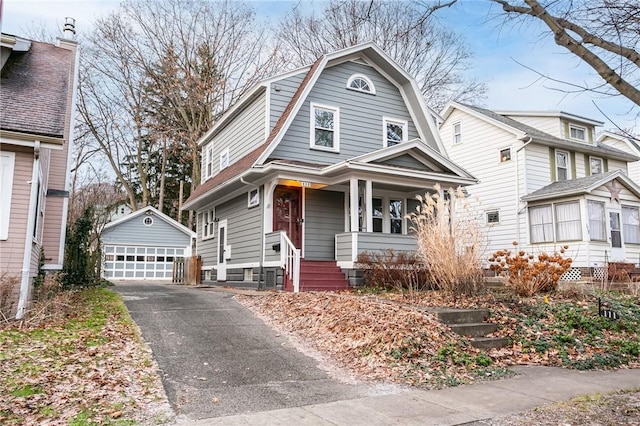 view of front property featuring an outbuilding, a porch, and a garage