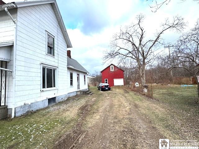 view of side of home with an outbuilding