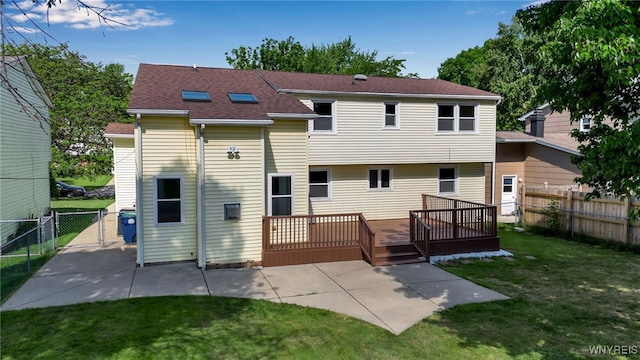 back of property with a yard, a patio, and a wooden deck