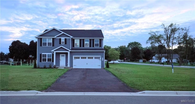 view of front of home with a garage and a front yard