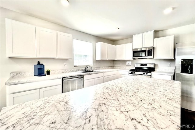 kitchen with white cabinetry, sink, and appliances with stainless steel finishes