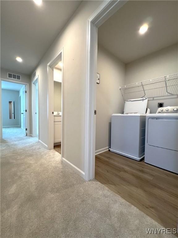 clothes washing area featuring independent washer and dryer