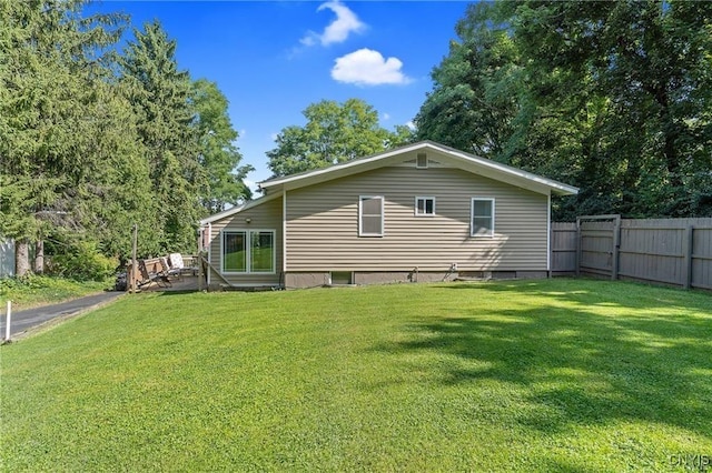 rear view of house featuring a lawn