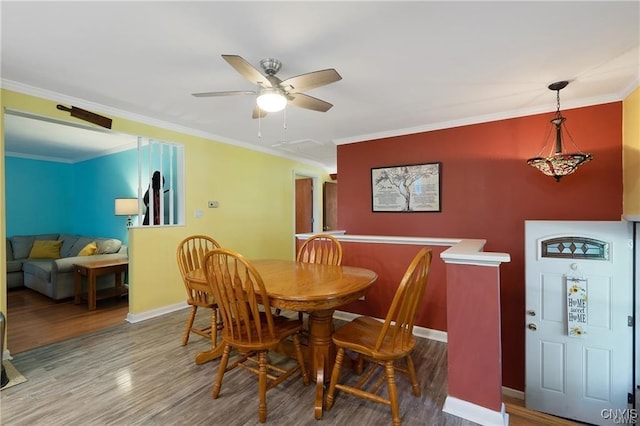 dining area featuring hardwood / wood-style flooring, ceiling fan, and ornamental molding