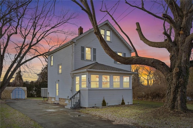 269 Rossmore St, Gates, NY 14606 - back house at dusk featuring a shed