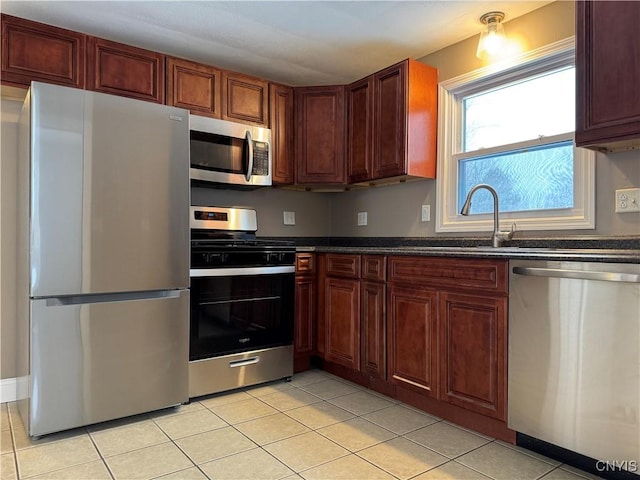 kitchen featuring sink, light tile patterned flooring, and appliances with stainless steel finishes