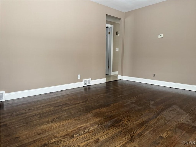 empty room with dark wood-type flooring