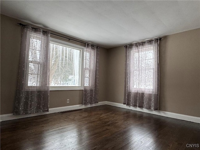 unfurnished room with dark hardwood / wood-style floors