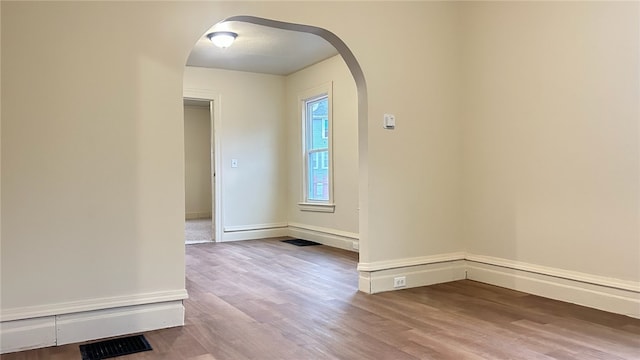 spare room with hardwood / wood-style floors