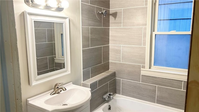 bathroom featuring tiled shower / bath and sink