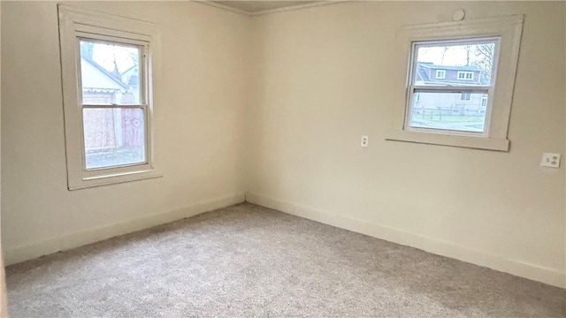 carpeted empty room featuring plenty of natural light