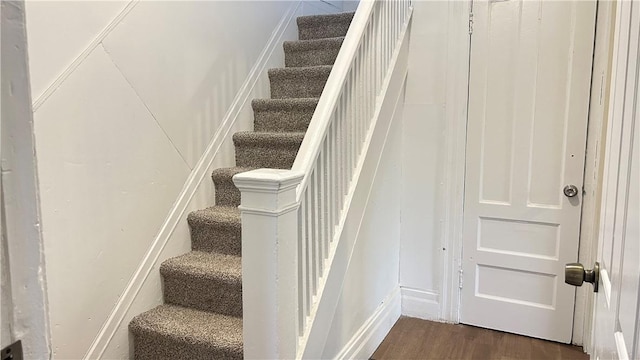 stairs featuring wood-type flooring