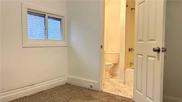 interior space featuring carpet floors and ensuite bath