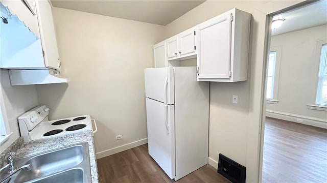 kitchen featuring light stone counters, white appliances, dark wood-type flooring, sink, and white cabinets