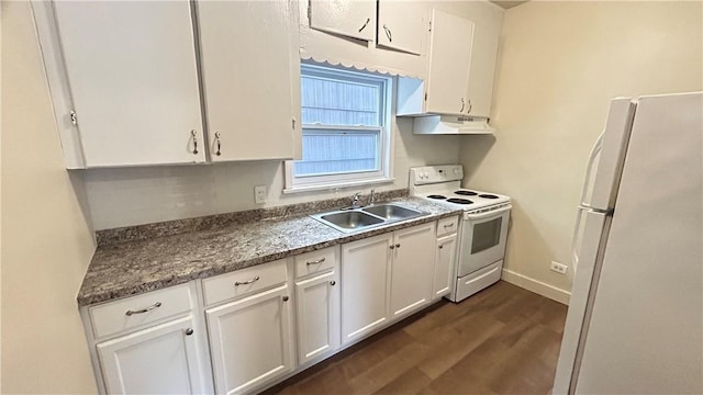 kitchen with white appliances, white cabinets, sink, dark stone countertops, and dark hardwood / wood-style flooring