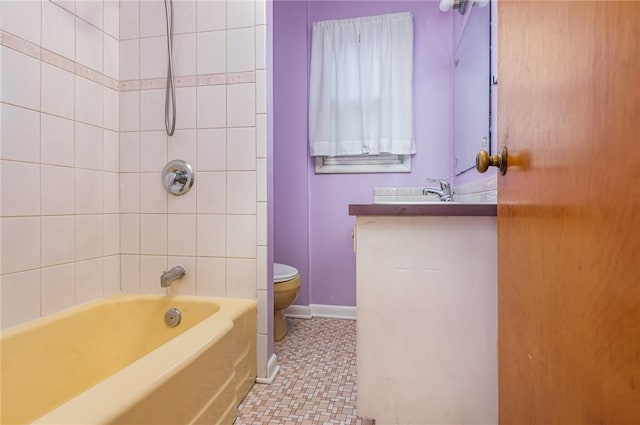 full bathroom featuring tile patterned floors, vanity, toilet, and tiled shower / bath