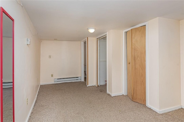 interior space with carpet flooring and a baseboard heating unit