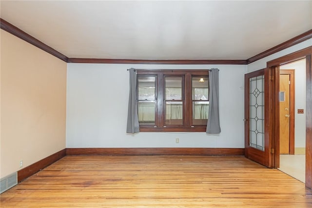 spare room with light hardwood / wood-style flooring and ornamental molding