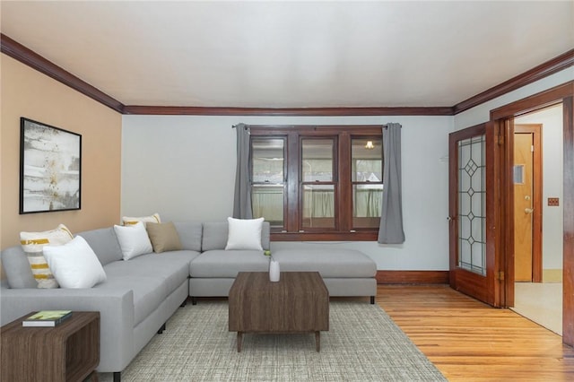 living room with light hardwood / wood-style floors and ornamental molding