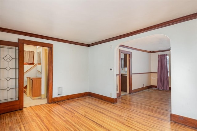 spare room featuring crown molding, ceiling fan, and light wood-type flooring