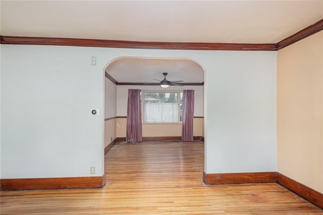 spare room with light hardwood / wood-style flooring, ceiling fan, and crown molding