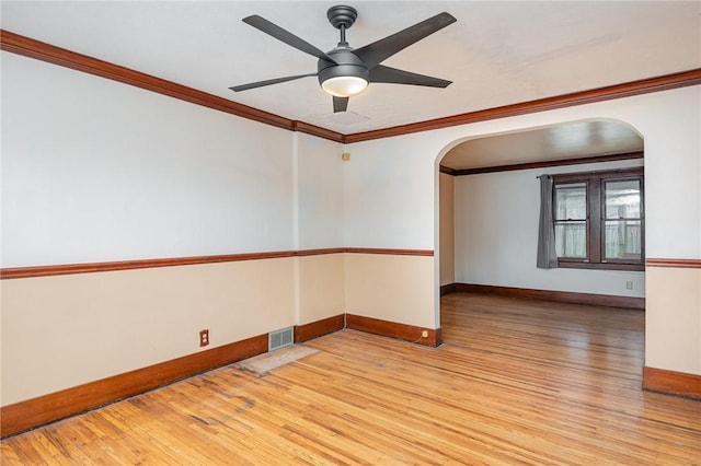 unfurnished room with ceiling fan, light wood-type flooring, and ornamental molding