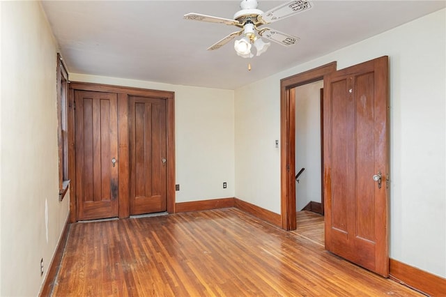 unfurnished bedroom featuring wood-type flooring and ceiling fan