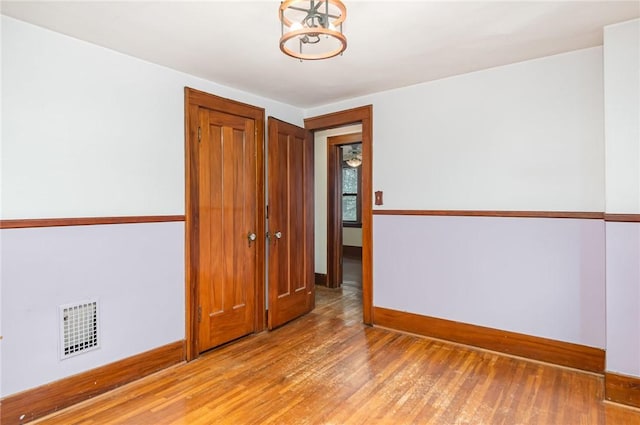 spare room with hardwood / wood-style floors