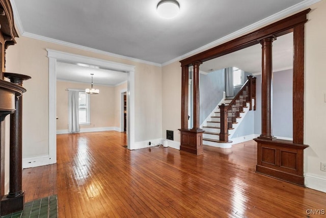 unfurnished living room featuring hardwood / wood-style flooring, an inviting chandelier, and crown molding