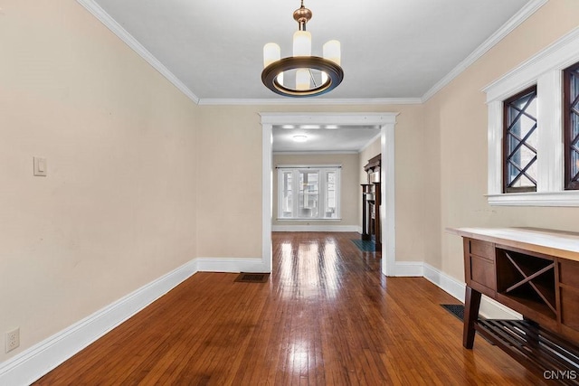 hallway featuring a notable chandelier, wood-type flooring, and ornamental molding