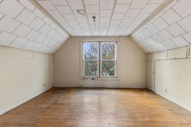 bonus room featuring light hardwood / wood-style flooring and lofted ceiling