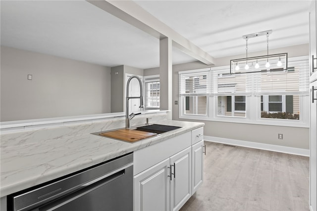 kitchen with light wood-type flooring, sink, pendant lighting, dishwasher, and white cabinetry