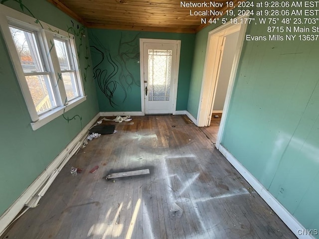 interior space with plenty of natural light, wood ceiling, and hardwood / wood-style flooring