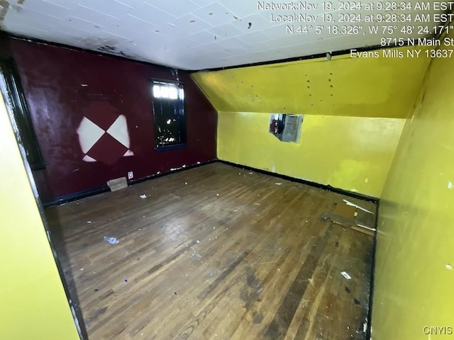 bonus room with hardwood / wood-style flooring and vaulted ceiling