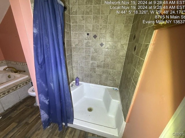 bathroom featuring hardwood / wood-style floors and walk in shower