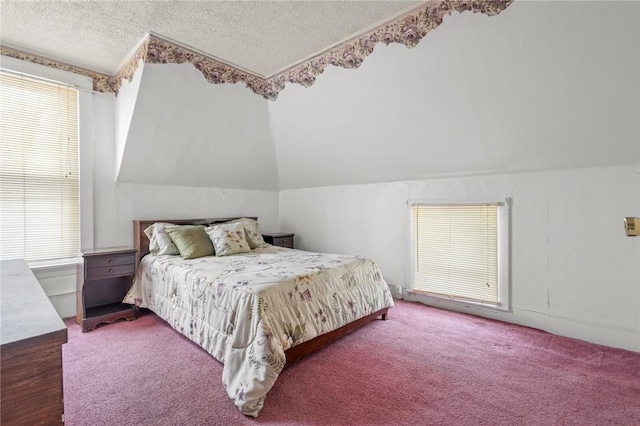 bedroom featuring vaulted ceiling, carpet flooring, and a textured ceiling