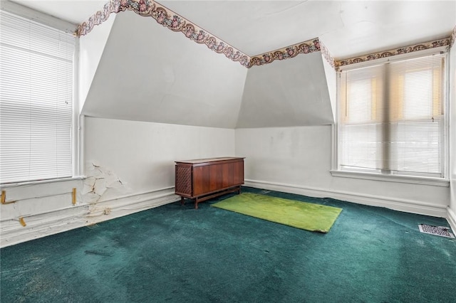 bonus room with carpet flooring and lofted ceiling