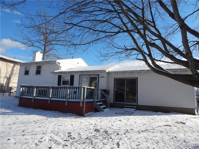 view of snow covered back of property