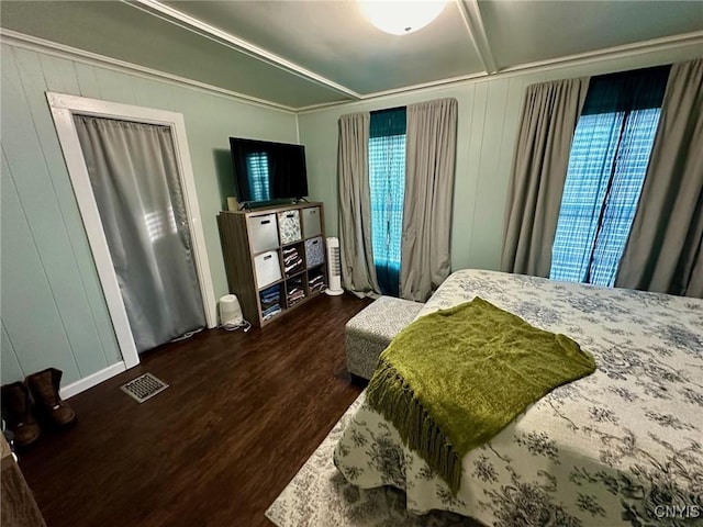 bedroom with dark wood-type flooring