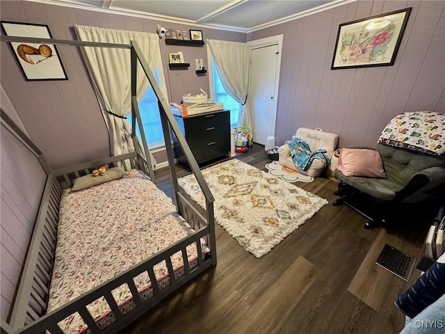 bedroom featuring dark hardwood / wood-style floors and ornamental molding