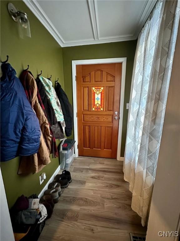 mudroom with crown molding and hardwood / wood-style flooring