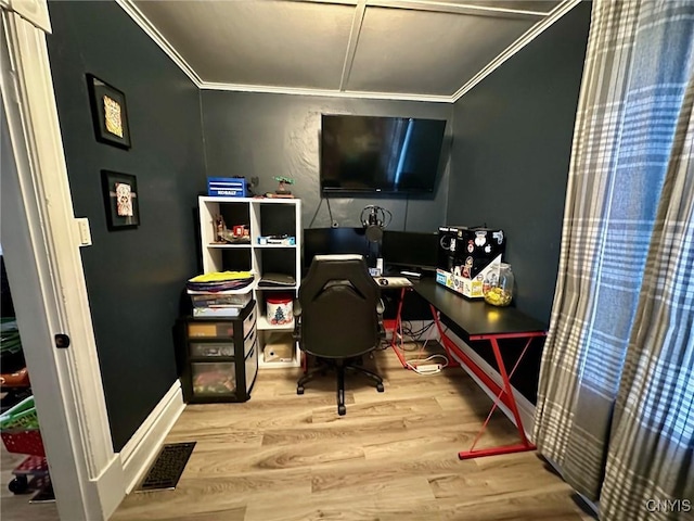 office with hardwood / wood-style flooring and crown molding